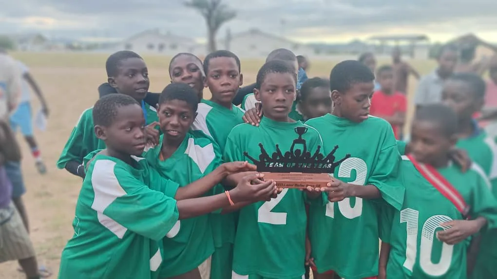 Magic Boys FC players gathered in a team huddle
